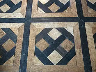 Détail de parquet du salon rouge.