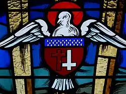 Vitrail avec le Saint Esprit et le blason paroissial de Gouttières.