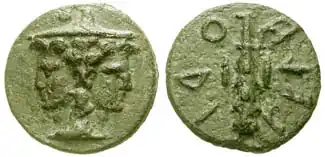 Monnaie en patine verte recto-verso avec d'un côté un aigle avec des inscriptions circulaires et de l'autre un homme à deux visages portant un couvre-chef.