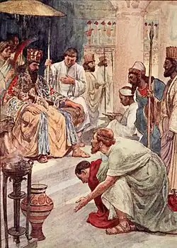 Illustration en couleur d'un homme s'agenouillant devant un autre assis sur un trône et accompagné de sa cour.