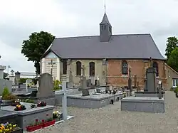 Vue sur l'église avec le cimetière et le calvaire.