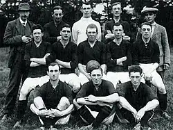 Players and staff pose for a photograph