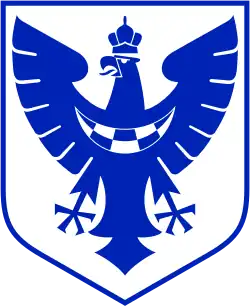 Un blason représentant un aigle bleu couronné sur fond blanc.